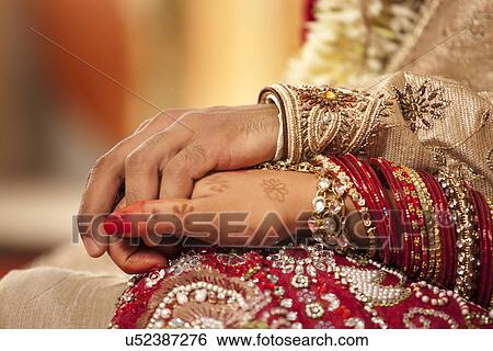 Close-up of groom holding brides hand View Large Photo Image Stock Photograph - Close-up of groom holding brides hand . Fotosearch