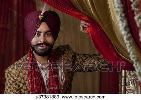 Close-up of groom wearing traditional Sikh wedding costume View Large Photo Image Stock Photo - Close-up of groom wearing traditional Sikh wedding costume . Fotosearch