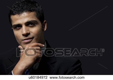 Stock Image - Close-up of handsome business man with confident smile . Fotosearch