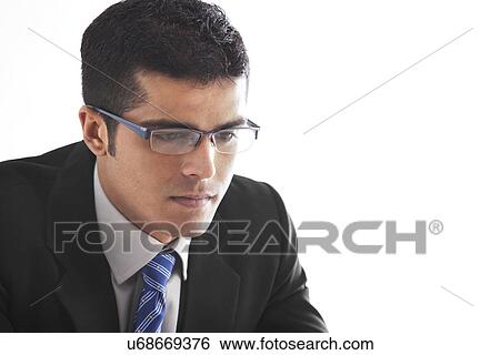 Stock Photograph - Close-up of handsome businessman contemplating over white background . Fotosearch