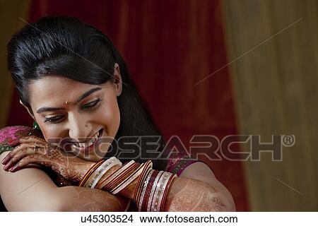 Close-up of happy young bride looking down View Large Photo Image Picture - Close-up of happy young bride looking down . Fotosearch