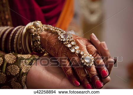 Picture - Close-up of human hands holding each other . Fotosearch