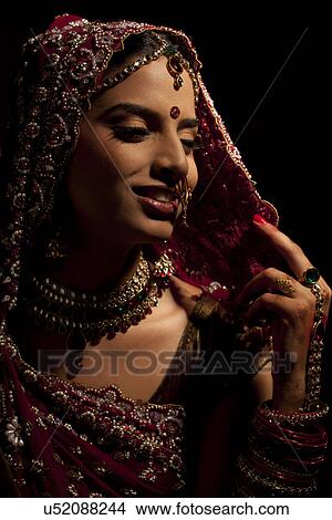 Close-up of Indian bride in wedding attire and jewelery View Large Photo Image Picture - Close-up of Indian bride in wedding attire and jewelery . Fotosearch