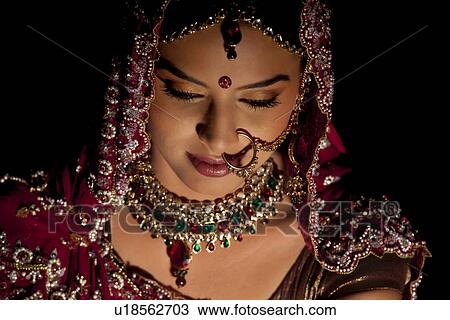 Stock Image - Close-up of Indian bride in wedding attire and jewelery . Fotosearch
