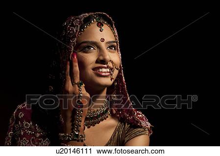 Close-up of Indian bride in wedding attire and jewelery View Large Photo Image Stock Image - Close-up of Indian bride in wedding attire and jewelery . Fotosearch