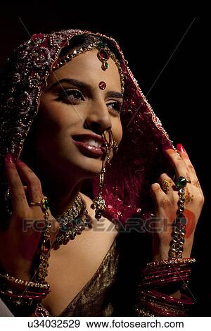 Stock Photo - Close-up of Indian bride in wedding attire and jewelery . Fotosearch