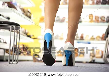 Stock Photo - Close-up of legs of a woman wearing heels . Fotosearch