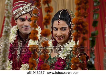 Close-up of newlywed couple looking away View Large Photo Image Stock Photo - Close-up of newlywed couple looking away . Fotosearch