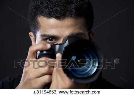 Close-up of photographer taking photograph against black background View Large Photo Image Stock Image - Close-up of photographer taking photograph against black background . Fotosearch