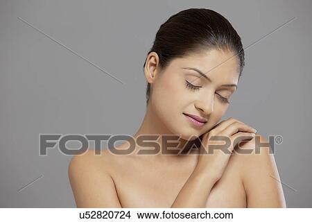 Picture - Close-up of pretty woman over grey background . Fotosearch