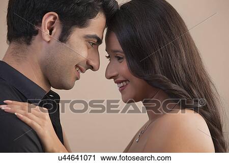 Close-up of romantic young couple looking at each other View Large Photo Image Stock Image - Close-up of romantic young couple looking at each other . Fotosearch