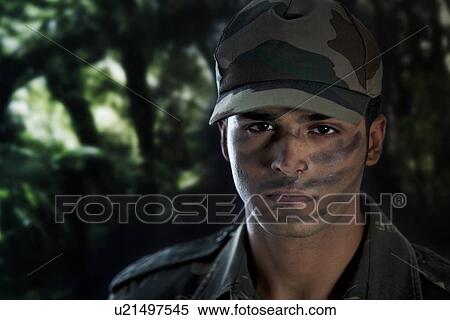 Stock Photography - Close-up of serious young man in military uniform . Fotosearch