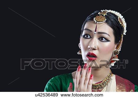Close-up of shocked Bharatanatyam dancer performing on black background View Large Photo Image Stock Photo - Close-up of shocked Bharatanatyam dancer performing on black background. Fotosearch