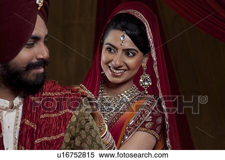 Stock Photography - Close-up of smiling couple looking at each other . Fotosearch