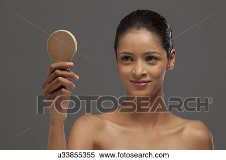 Close-up of smiling woman looking at hand mirror View Large Photo Image Stock Photography - Close-up of smiling woman looking at hand mirror . Fotosearch