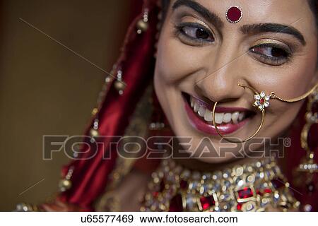 Stock Photo - Close up of smiling young bride looking away . Fotosearch
