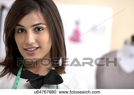 Close-up of smiling young fashion designer in clothing store View Large Photo Image Stock Image - Close-up of smiling young fashion designer in clothing store . Fotosearch