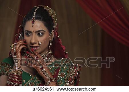 Close up of surprised young bride while talking on mobile phone View Large Photo Image Stock Image - Close up of surprised young bride while talking on mobile phone . Fotosearch