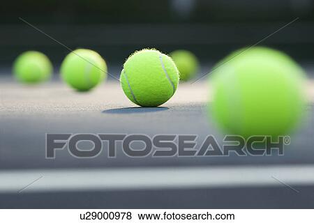 Close-up of tennis balls lying on ground View Large Photo Image Stock Photo - Close-up of tennis balls lying on ground . Fotosearch