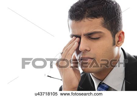 Stock Photography - Close-up of tired businessman over white background . Fotosearch
