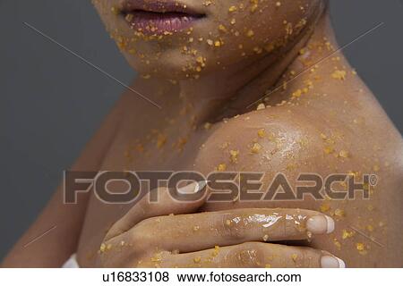 Close-up of woman applying scrub on her body View Large Photo Image Stock Photo - Close-up of woman applying scrub on her body . Fotosearch