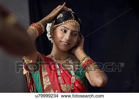 Close-up of woman getting ready while looking away View Large Photo Image Picture - Close-up of woman getting ready while looking away . Fotosearch