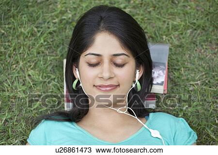 Close-up of woman listening to music View Large Photo Image Stock Image - Close-up of woman listening to music . Fotosearch