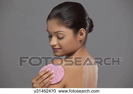 Close-up of woman using massage sponge View Large Photo Image Stock Image - Close-up of woman using massage sponge . Fotosearch