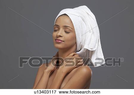 Close-up of woman with a towel on head View Large Photo Image Stock Photo - Close-up of woman with a towel on head . Fotosearch