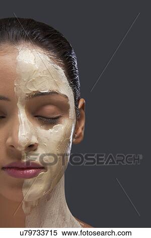 Close-up of woman with facial mask over colored background View Large Photo Image Stock Photography - Close-up of woman with facial mask over colored background . Fotosearch