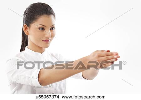 Picture - Close-up of woman with hands clasped doing yoga over white background . Fotosearch