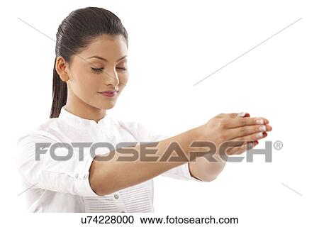 Close-up of woman with hands clasped and eyes closed doing yoga over white background View Large Photo Image Stock Image - Close-up of woman with hands clasped and eyes closed doing yoga over white background . Fotosearch