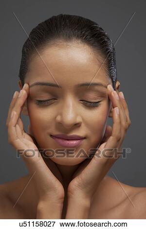 Close-up of woman with her eyes closed and fingers on temples View Large Photo Image Stock Photo - Close-up of woman with her eyes closed and fingers on temples . Fotosearch