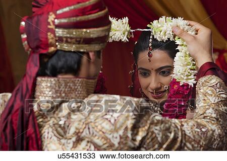 Close-up of young couple during wedding ceremony View Large Photo Image Stock Image - Close-up of young couple during wedding ceremony . Fotosearch