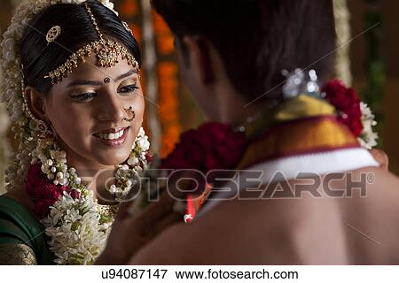 Close-up of young couple during wedding ceremony View Large Photo Image Stock Photo - Close-up of young couple during wedding ceremony . Fotosearch