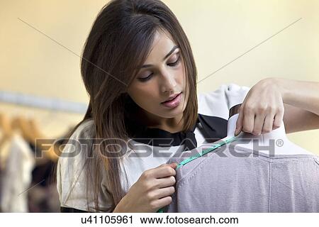 Close-up of young fashion designer measuring the dress View Large Photo Image Stock Image - Close-up of young fashion designer measuring the dress . Fotosearch
