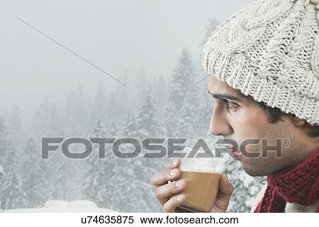 Close-up of young man drinking tea with trees in the background View Large Photo Image Stock Photography - Close-up of young man drinking tea with trees in the background . Fotosearch