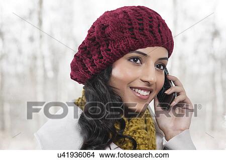 Picture - Close-up of young smiling woman having conversation on mobile phone . Fotosearch