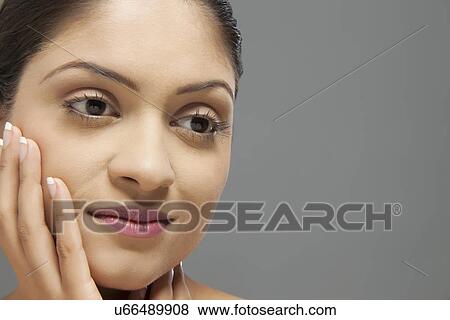Stock Photo - Close-up of young woman looking away . Fotosearch