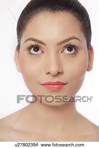 Close-up of young woman looking up View Large Photo Image Picture - Close-up of young woman looking up . Fotosearch