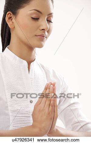 Close-up of young woman meditating View Large Photo Image Stock Image - Close-up of young woman meditating . Fotosearch