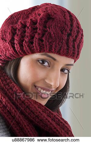 Close-up of young woman wearing woolen hat and smiling View Large Photo Image Stock Photograph - Close-up of young woman wearing woolen hat and smiling . Fotosearch