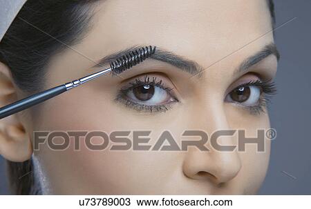 Close-up of young woman with eyebrow tinting applicator over colored background View Large Photo Image Stock Image - Close-up of young woman with eyebrow tinting applicator over colored background . Fotosearch