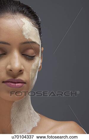 Stock Photo - Close-up of young woman with facial mask . Fotosearch