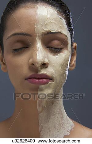 Close-up of young woman with facial mask View Large Photo Image Stock Photo - Close-up of young woman with facial mask . Fotosearch