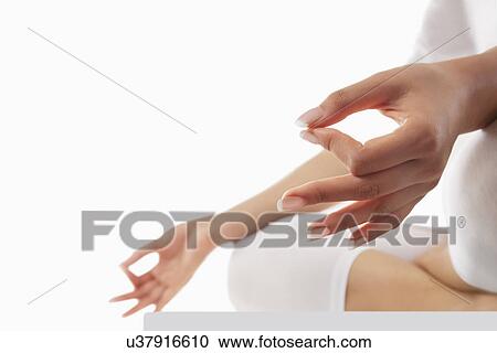 Stock Image - Close-up of young woman's hand with yoga gesture called guyan mudra . Fotosearch