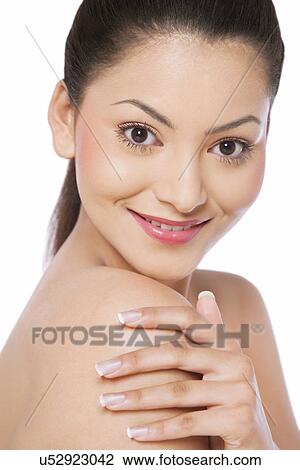 Close-up portrait of a woman touching her shoulder View Large Photo Image Stock Image - Close-up portrait of a woman touching her shoulder . Fotosearch