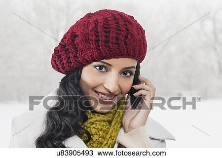 Stock Image - Close-up portrait of beautiful woman talking on cell phone . Fotosearch