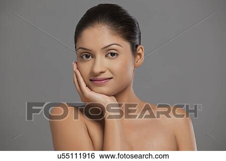 Close-up portrait of beautiful woman touching her face View Large Photo Image Stock Photograph - Close-up portrait of beautiful woman touching her face . Fotosearch