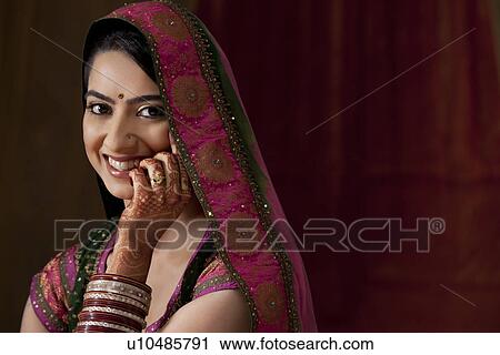 Stock Image - Close-up portrait of smiling young bride . Fotosearch